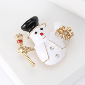 Christmas snowman brooch with white enamel, sparkling rhinestones and golden broom detail