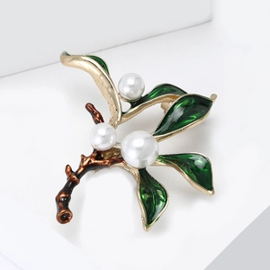 Elegant garden style green enamel plant brooch with gold plating and white pearls