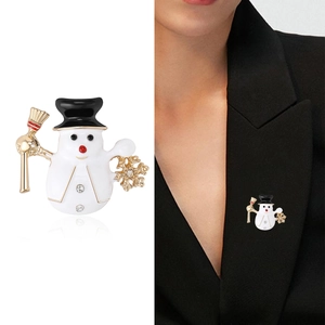 Christmas snowman brooch with enamel finish and sparkling rhinestone accents on suit lapel