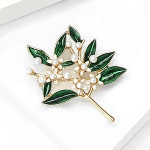 Elegant green enamel plant brooch with small white flowers and faux pearls on gold base
