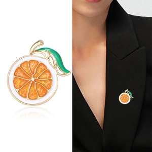 Cartoon orange slice enamel brooch with green leaf on a black suit lapel pin