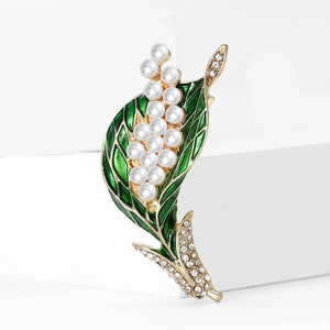 Elegant lily of the valley brooch with green enamel leaves and white pearls on gold base