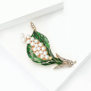 Elegant lily of the valley brooch with green enamel leaves and white pearls on gold base