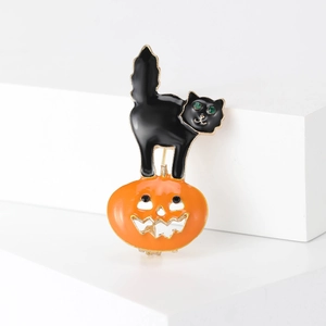 Broche citrouille d'Halloween et chat noir avec yeux en cristal vert sur socle blanc
