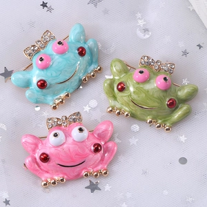 Cartoon frog enamel brooches with marble texture and rhinestone bows in three colors