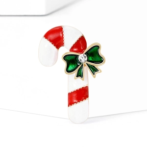Christmas candy cane brooch with red and white enamel stripes and green bow accent