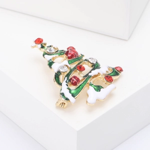 Close-up of alloy Christmas tree brooch with green enamel and sparkling rhinestones