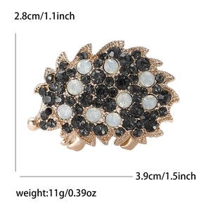 Vintage rhinestone hedgehog brooch with black and milky crystals on a gold setting