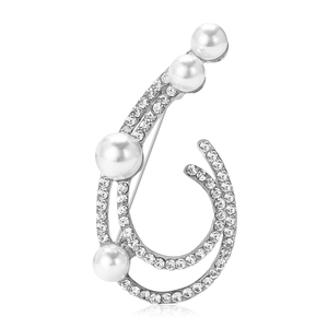 Elegant silver-toned brooch featuring white pearls and shimmering rhinestones on white