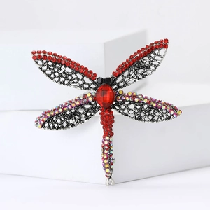 Vintage silver dragonfly brooch with red rhinestones and intricate filigree wings