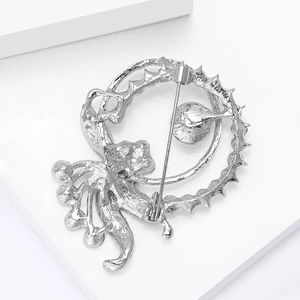 Detailed view of the silver octopus brooch back featuring a secure metal safety pin closure