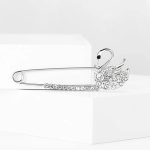 Close-up of elegant silver swan brooch featuring sparkling crystal pavé and black stone eye