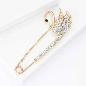 Elegant swan brooch with rhinestones and alloy plating on a white geometric stand