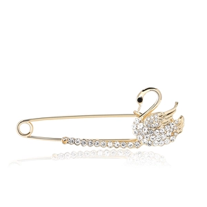 Exquisite gold plated swan brooch pin with sparkling rhinestones on white background