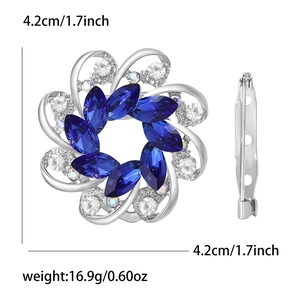 Detail view of floral brooch with blue gems and white diamonds showing 4.2cm diameter size