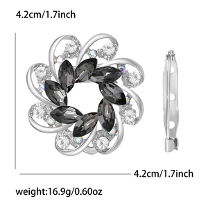 Detailed view of flower-shaped brooch with black rhinestones, size 4.2cm and 16.9g weight