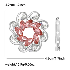 Detail view of flower brooch with red marquise gems and clear rhinestones plus pin lock