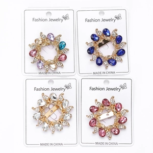 Macro detail of 4pcs crystal flower brooch and scarf ring with colorful rhinestones
