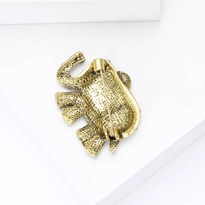 Back view of vintage gold elephant brooch with secure pin clasp and textured metal alloy