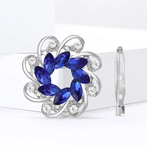 Exquisite silver flower brooch with blue crystal petals and sparkling rhinestone details