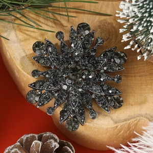 Vintage gun black snowflake brooch with grey rhinestones on festive winter decor