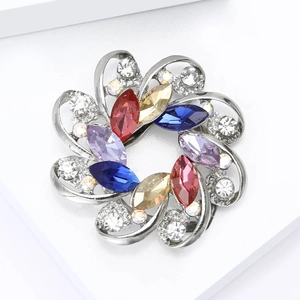 Detailed macro view of floral brooch with multi-colored crystals and sparkling white zircons