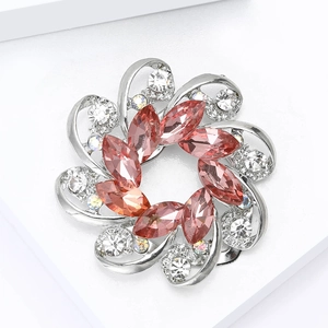 Detail of pink crystal flower brooch with silver swirls and white zirconia stones