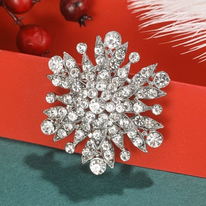 Close-up of vintage gun-black floral brooch with crystal rhinestones in holiday setting