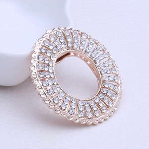 Detailed close-up of a floral rhinestone scarf buckle with rose gold plating