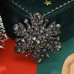 Macro detail of gunmetal vintage floral brooch with charcoal crystals on velvet