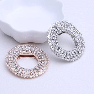 Close-up of alloy rhinestone brooch and scarf clip in rose gold and silver finishes