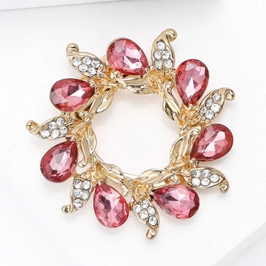Detail view of flower brooch with pink pear-cut crystals and sparkling pavé diamonds