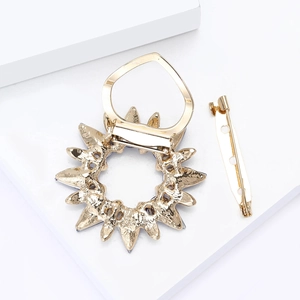 Detail view of the gold-tone metal scarf clip back mechanism and safety pin attachment