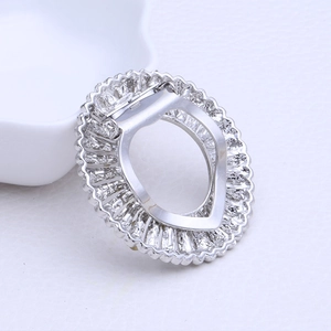 Macro detail of silver alloy scarf clip with pavé rhinestones and spring clamp mechanism