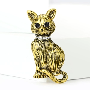 Detailed macro view of vintage cat brooch with gold finish and sparkling rhinestone collar