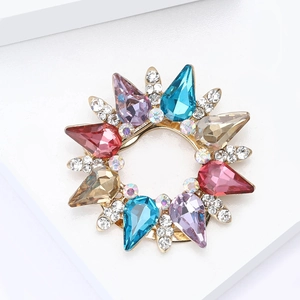 Macro view of gold-tone scarf clip with multi-color teardrop crystals and small white rhinestones