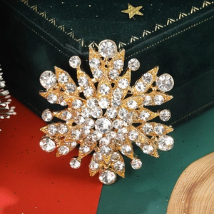 Detail of vintage gun black floral brooch with crystals on green velvet jewelry box