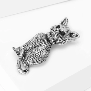 Close-up of vintage cat brooch with silver fur texture and sparkling diamond collar