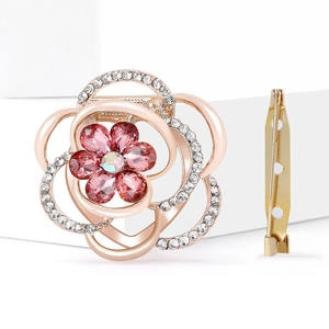 Floral crystal brooch scarf clip with pink petals and rose gold finish on white stand