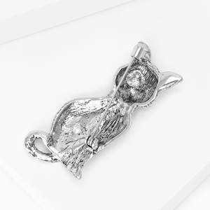 Macro shot of the cat brooch reverse side showing the secure metal safety pin clasp