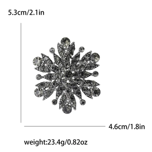 Vintage gun-black snowflake brooch with full rhinestones, measuring 5.3cm across