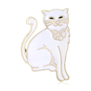 Elegant white enamel cat brooch with gold plating and bow detail on a white reflective base