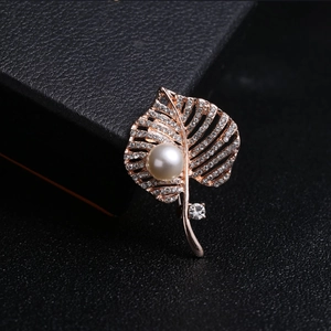 Elegant rose gold leaf brooch with pavé diamonds and white pearl on black gift box