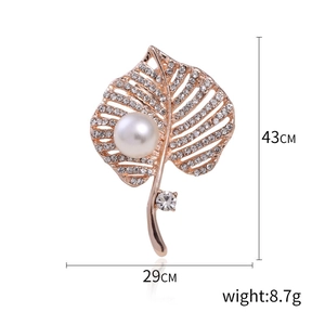 Elegant rose gold hollow leaf brooch with sparkling diamonds and a large white pearl