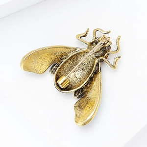 Vintage insect brooch in bronze gold finish with relief texture and safety pin backing