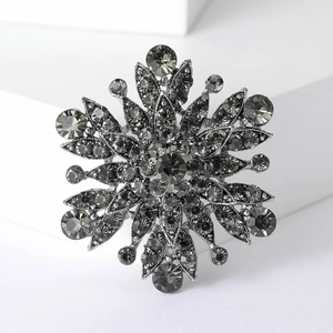 Macro shot of vintage gun-black snowflake brooch with shimmering smokey grey rhinestones