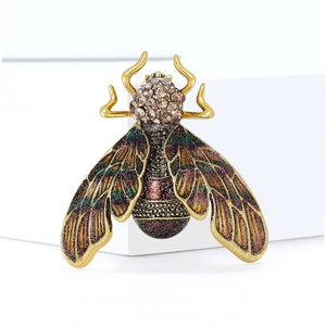 Exquisite golden insect brooch featuring crystal inlay and vintage green enamel details