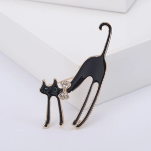 Broche chaton en émail noir avec bordure dorée et yeux en strass verts pour femmes