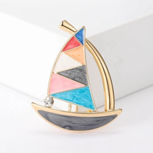 Luxurious enamel sailboat brooch with colorful sails and sparkling rhinestone accent