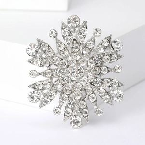 Macro detail of gun black floral brooch with sparkling rhinestones and multi-layer design